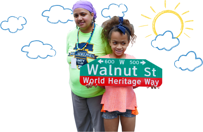 Two students stand in front of a background of cartoon clouds and sun. The student on the left side has a purple bandana and green shirt, the student on the right side has a pink shirt and shorts, she is holding a street sign that reads Walnut Street World Heritage Way.
